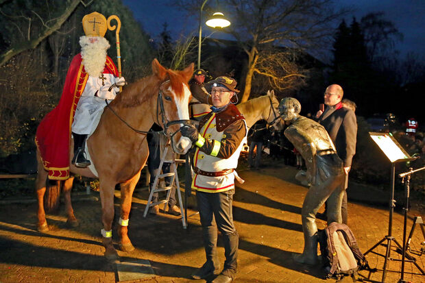 Pfarrer Thomas Metten von der katholischen Kirchengemeinde begrüßte den "Heiligen Nikolaus" (Knut Hornkamp) mit seinen Pferdeknechten des Reiterhofes Arndt auf dem Dorfplatz in Wiehagen. FOTO: ANDREAS DUNKER