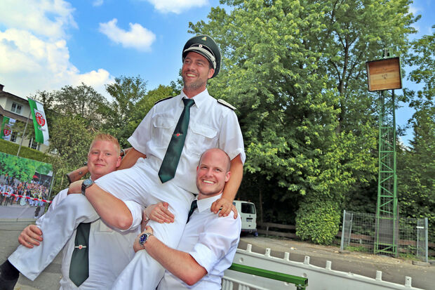 Daniel „Borsti“ Weische (links) und Johannes Korte (rechts) lassen den neuen Schützenkönig hochleben. FOTO: ANDREAS DUNKER